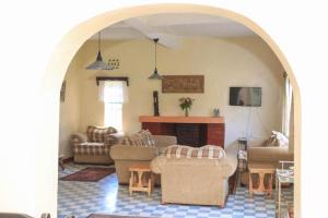 a living room with couches chairs and a table at Nyahururu Highlands Heaven -BnB in Nyahururu