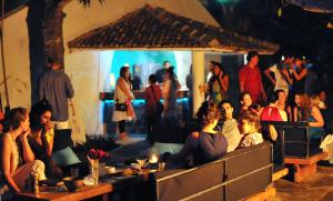 a group of people sitting at tables in a restaurant at Closenberg Hotel in Galle