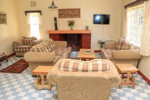 a living room with couches and a fireplace at Nyahururu Highlands Heaven -BnB in Nyahururu