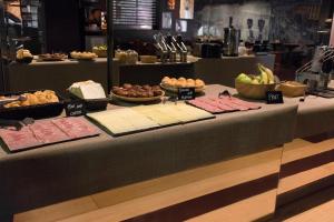 a table with different types of food on it at Kabul Party Hostel Barcelona in Barcelona