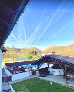 a pavilion with a picnic table and benches and mountains at Maison " Elixondoa " in Pagolle