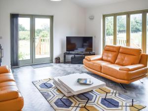 a living room with a couch and a coffee table at Deerson Barn in Wingham