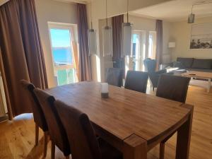 a dining room table with chairs and a living room at Visum Mare in Alt Reddevitz