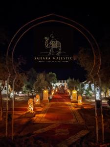 een teken voor het Sikharma musket instituut 's nachts bij Sahara Majestic Luxury Camp in Merzouga
