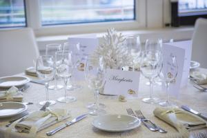 a table with wine glasses and silverware on it at HR Hotel & Spa in Piano di Sorrento