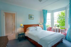 a bedroom with a large bed and a window at Bear's Well Bed & Breakfast in Deal