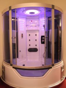 a small bathroom with purple lighting in a room at Hotel Green in Tirana