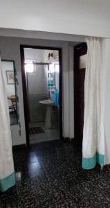 a room with a bathroom with a shower and a sink at BELACHA - Casa de Playa in Costa Azul