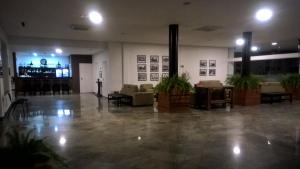 a lobby with couches and chairs in a building at Galeria hotel in Jaú