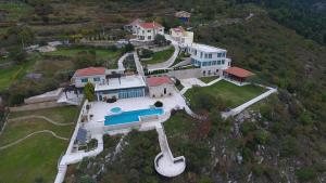 an aerial view of a large house with a swimming pool at Villa Eagle Eye Montenegro in Kotor