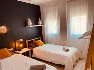 A bed or beds in a room at BEACH HOUSE !