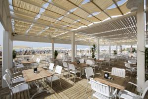 a rendering of a restaurant with tables and chairs at TUl BLUE Xanthe - Ultra All Inclusive in Side