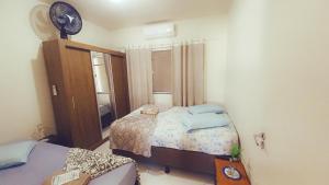 a small bedroom with a bed and a mirror at Casa_Margarida in Penha