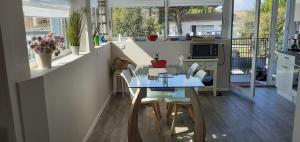 a kitchen with a blue table and chairs in a room at Villa Louna in Châtelaillon-Plage