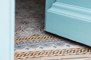 a close up of a tile floor with a blue door at Villa 216 in Lyon