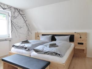 two twin beds in a room with a bench at Family Mountain Winterberg Chalet privates Haus 10 Pers 4 Schlafzimmer WiFi near Lift in Winterberg +35 photos