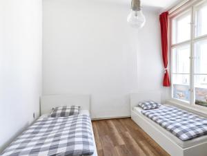 two beds in a room with two windows at Love Croatia Hostel-Mir Guesthouse Zagreb in Zagreb