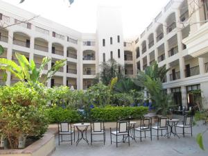 a courtyard with tables and chairs in front of a building at Solymar Ivory Suites in Hurghada