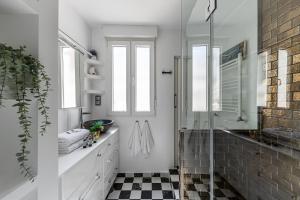 マドリードにあるBNBHolder Spacious Dream SOLの黒と白のチェッカーフロアのバスルーム(ガラス張りのシャワー付)