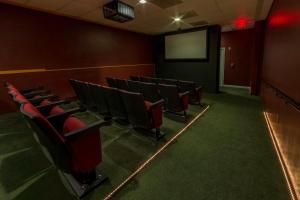 a lecture room with red chairs and a screen at Holiday Inn Club Vacations Oak n Spruce Resort in the Berkshires an IHG Hotel in South Lee