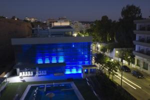 a building with blue lights on it at night at Hotel Bretagne in Loutraki