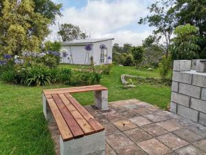 a wooden bench sitting in the middle of a yard at Windygates Estate Rustic Window Cottage in Thornhill