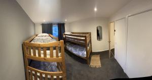 two bunk beds in a room with a hallway at House Sleeps 8. 2bedrooms & sofa beds in sitting room in Bath