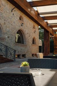 a patio with a table with a plant on it at Tenuta Un Posto Al Sole Luxury B&B in Rossano Stazione