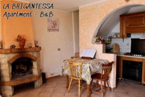 a kitchen with a table with a laptop on it at La brigantessa in Sante Marie