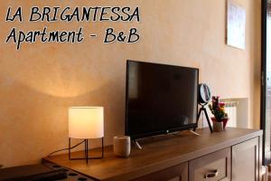 a flat screen tv sitting on top of a dresser at La brigantessa in Sante Marie