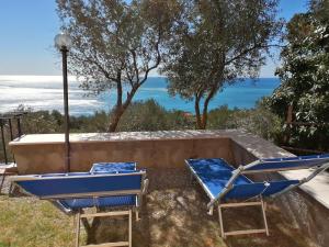 a couple of chairs and a table and a pool at Perla del Levante Hostel in Framura