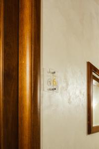 a lightswitch on a wall next to a door at Tenuta Un Posto Al Sole Luxury B&B in Rossano Stazione