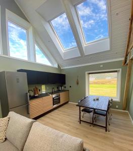 a kitchen with a skylight and a table in a living room at Stave Camping & Hot Pools in Stave
