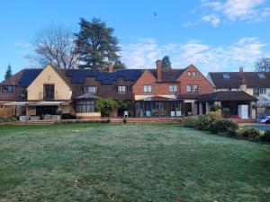 a large house with a yard in front of it at Remarkable 7 Bedroom Family House in Farnborough in Farnborough