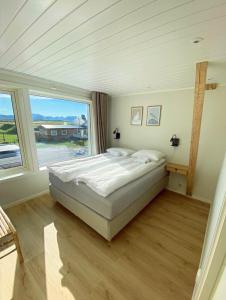 a bedroom with a bed and a large window at Stave Camping & Hot Pools in Stave
