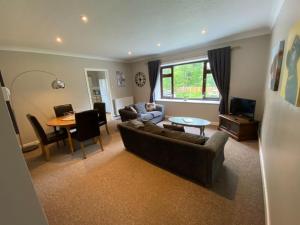 a living room with a couch and a table at South Lodge - Uk31880 in Newton Stewart