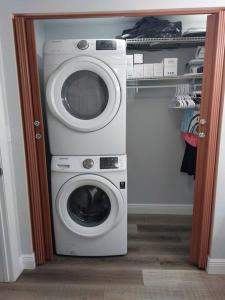 a washing machine and a washer in a closet at Torres Tiny Home Midtown WestTampa RJS in Tampa