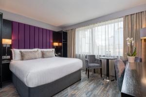 Voodi või voodid majutusasutuse The Trinity City Hotel toas