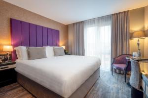 Voodi või voodid majutusasutuse The Trinity City Hotel toas