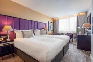 Voodi või voodid majutusasutuse The Trinity City Hotel toas