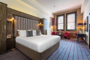Voodi või voodid majutusasutuse The Trinity City Hotel toas