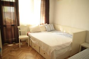 a small bedroom with a bed with a window at Elie's Home in Varna City