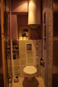 a small bathroom with a toilet and a lamp at Elie's Home in Varna City