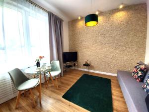 een woonkamer met een bank en een tafel bij Rental Apartments Smolna in Warschau