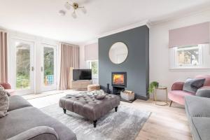 a living room with a couch and a fire place at Captivating 4-Bed House in Killin in Killin