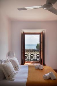 a bedroom with a bed with a view of the ocean at Charming Apartment in Alfama with River View in Lisbon