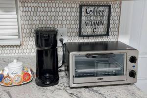 a microwave sitting on a counter next to a blender at The Torres' Loft West Tampa MidTown Raymond James Stadium in Tampa