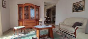 a living room with a couch and a table at White Column House in Diósd