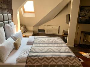 a bedroom with a large bed in a attic at Arbio I Apartmently Studios & Apartments in Berlin