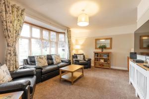 a living room with a couch and a table at St Clements House - Norfolk Holiday Properties in Norwich